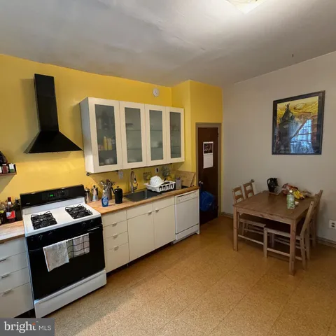 a kitchen with stainless steel appliances a stove a sink and a refrigerator