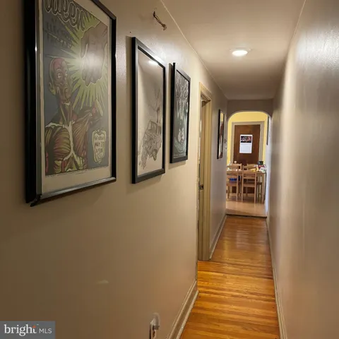 a view of a hallway with wooden floor