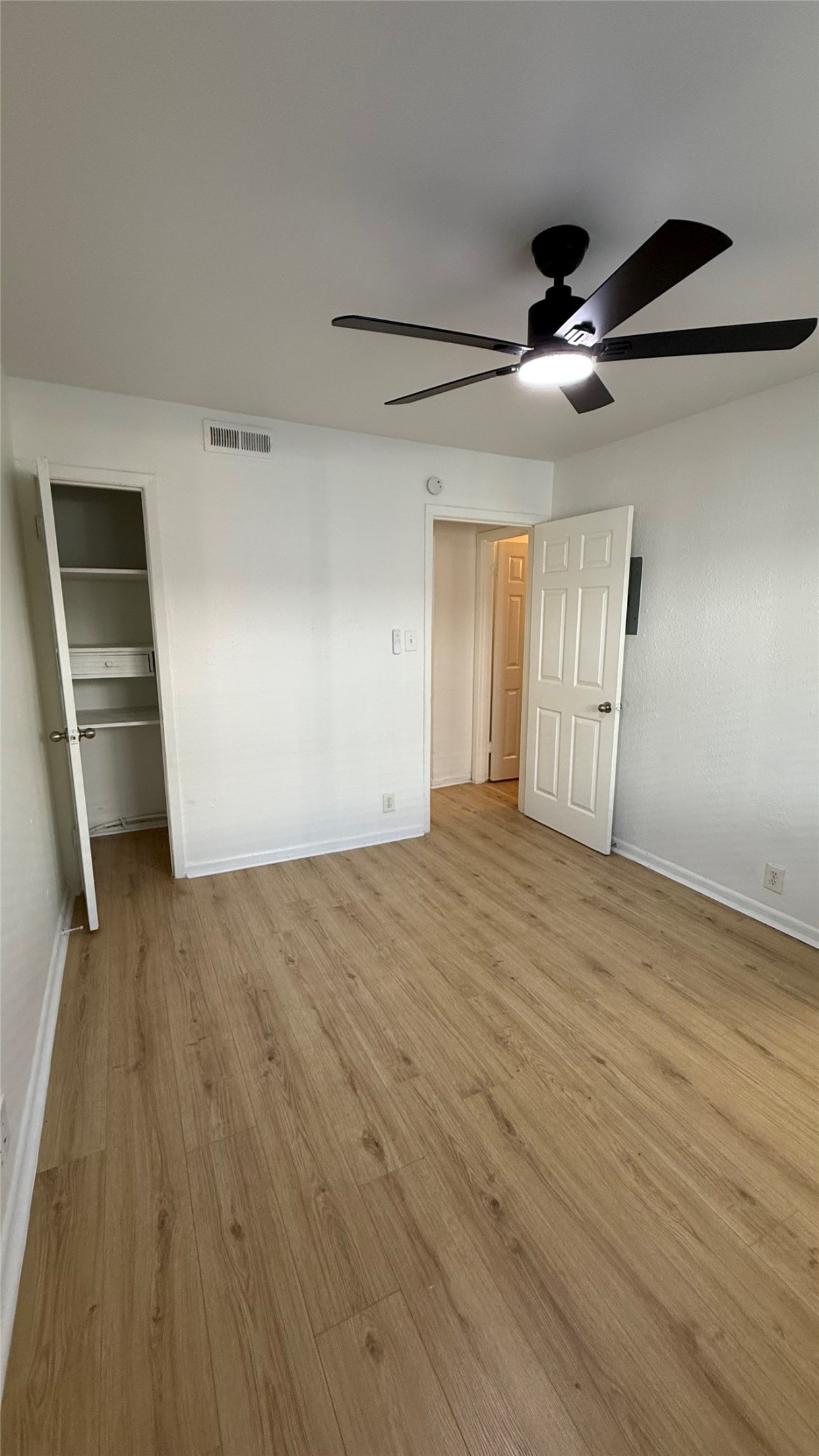 2401 Manor Road, Unit 126 Austin, TX 78722 - Photo 12 of 12 a view of empty room with wooden floor and fan