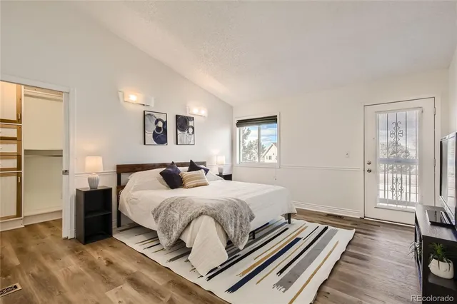 a bedroom with a bed next to a window