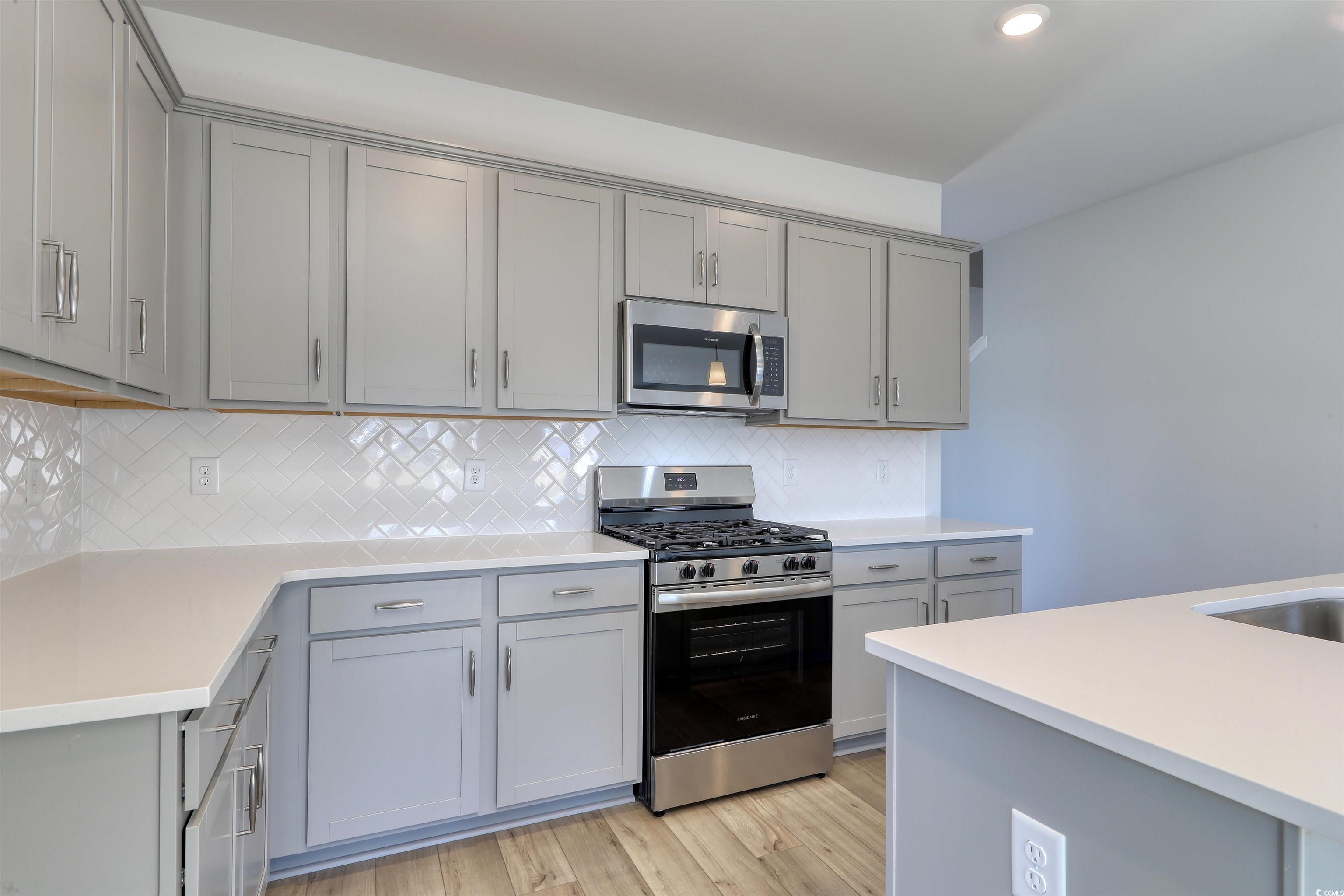 712 St Albans Loop Conway, SC 29526 - Photo 6 of 39 Kitchen with gray cabinetry, light hardwood / wood