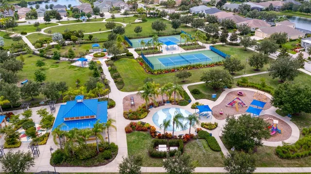 an aerial view of residential houses with outdoor space and pool