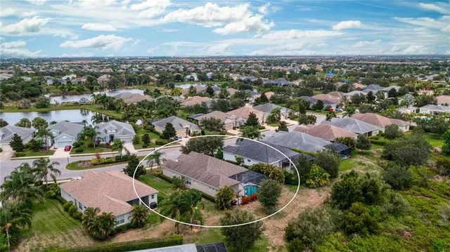 an aerial view of multiple houses with yard