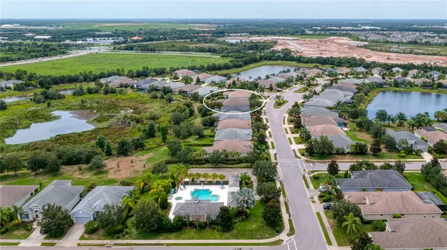 an aerial view of residential building and lake