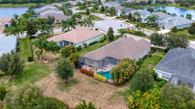 an aerial view of house with yard swimming pool and outdoor seating