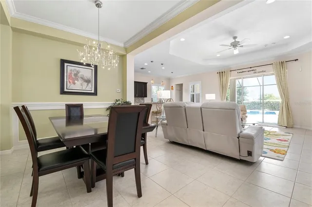 a view of a dining room with furniture and a chandelier