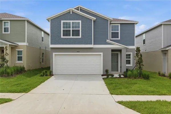 a front view of a house with a yard and garage