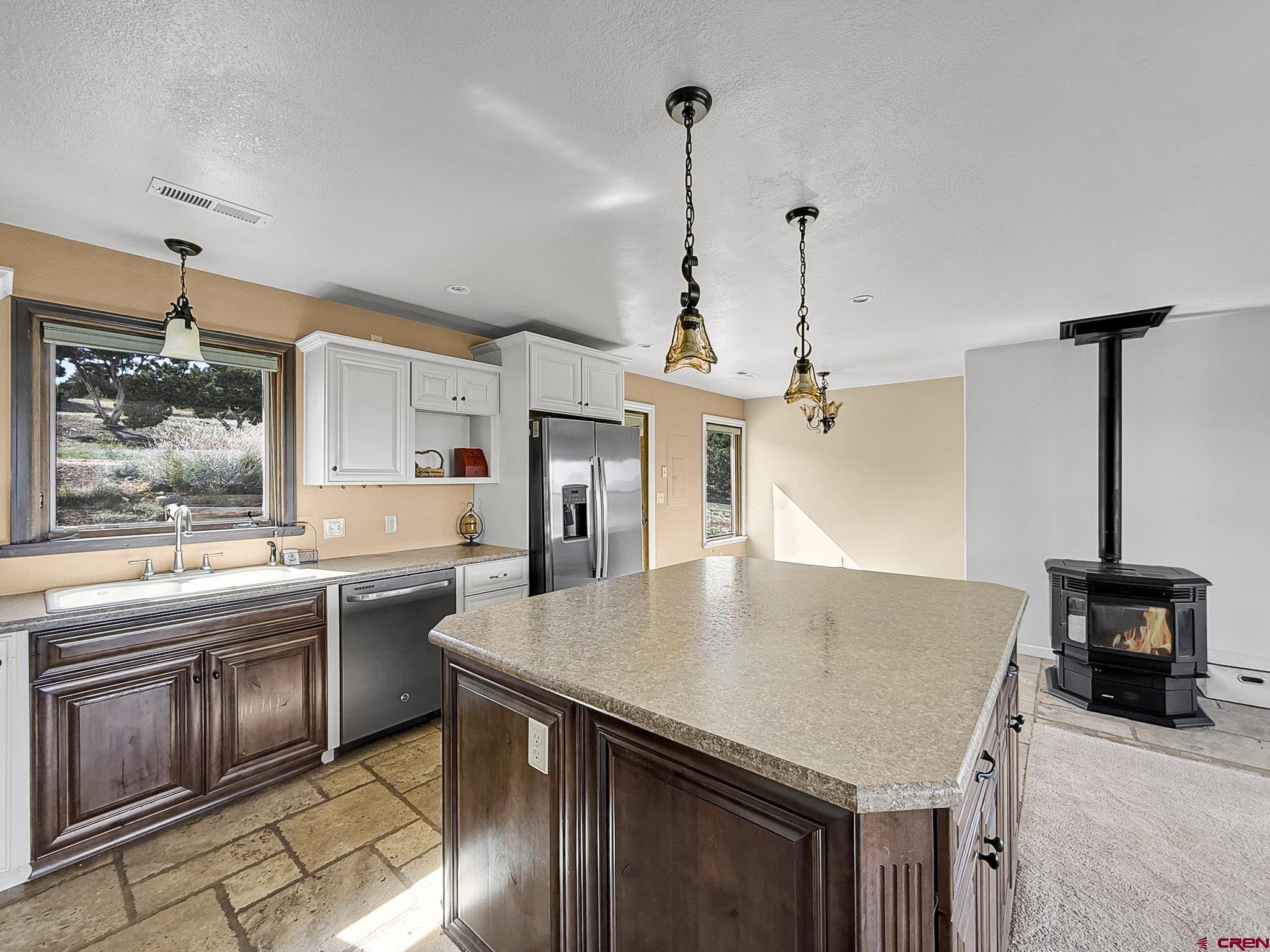 32310 B50 Road Crawford, CO 81415 - Photo 12 of 45 a kitchen with stainless steel appliances granite countertop a sink a stove and a wooden floors