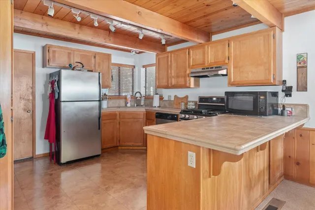 a kitchen with stainless steel appliances granite countertop a stove and a sink