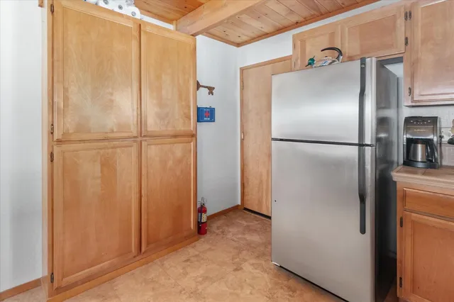 a bedroom with a large bed and wooden floor