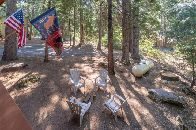 a view of house with deck outdoor seating and green space