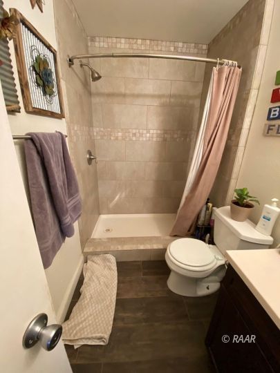 224 West Benson Avenue Ridgecrest, CA 93555 - Photo 4 of 6 a white toilet sitting next to a bath tub and a shower