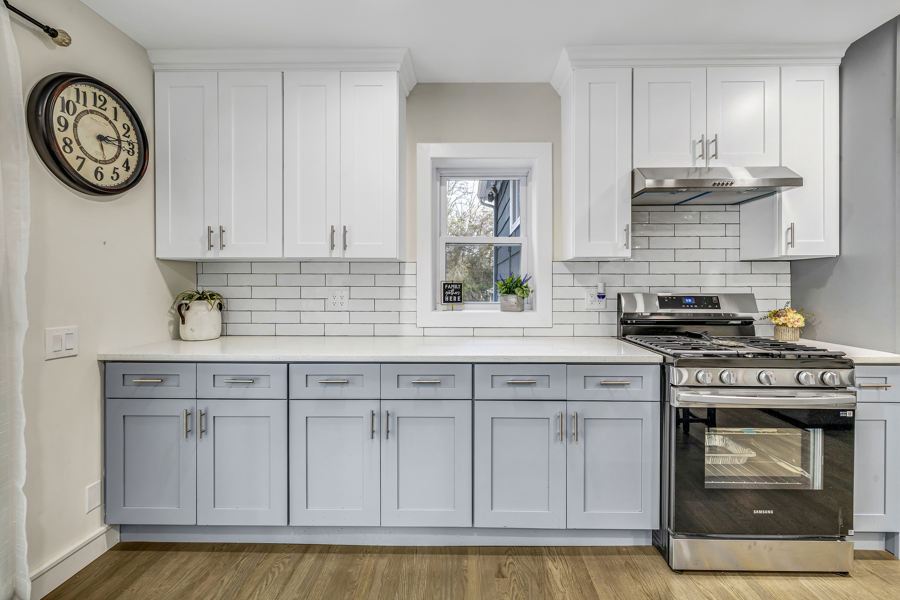 13 School Street Monroe, CT 06468 - Photo 4 of 29 a kitchen with white cabinets and clock
