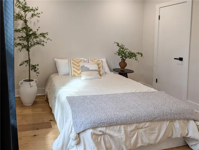 a bedroom with a bed and a potted plant
