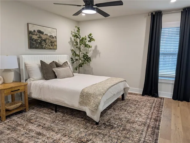 a bedroom with a bed and a painting on the wall