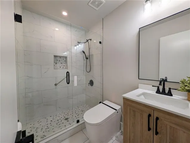 a bathroom with a sink toilet and shower