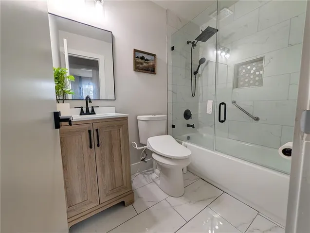 a bathroom with a toilet sink and shower