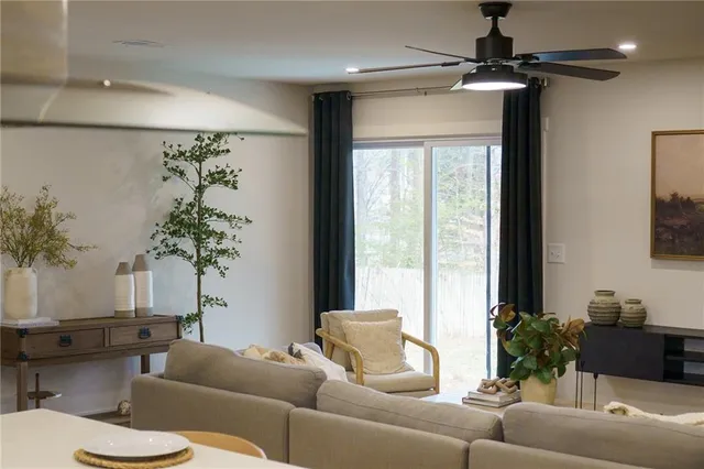 a living room with furniture and a potted plant