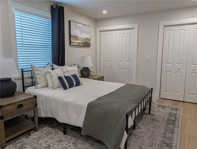 a bedroom with bed and a window