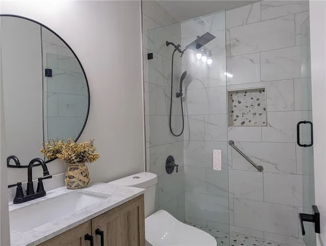 a bathroom with a sink toilet and shower