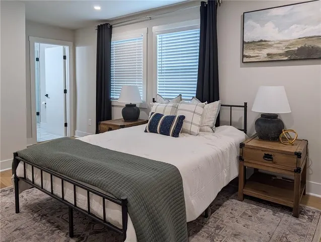 a bedroom with a bed and a painting on the wall