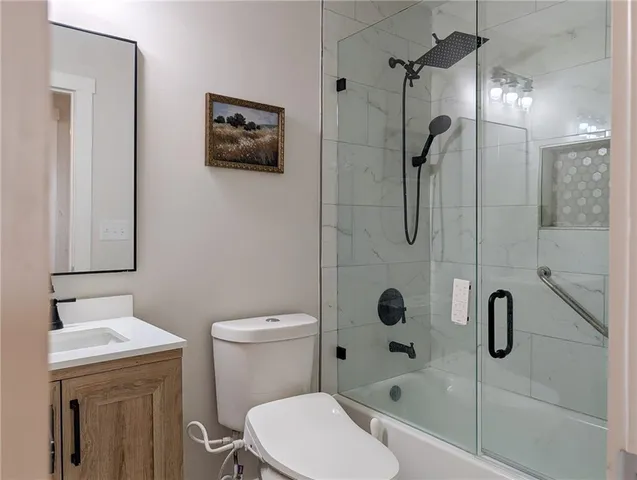 a bathroom with a shower a toilet and sink