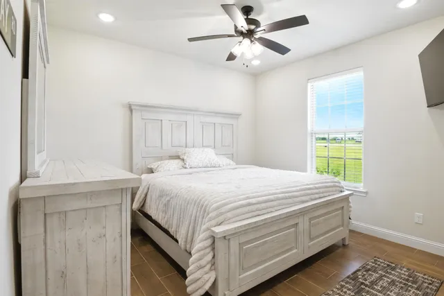 a bedroom with a bed and a window