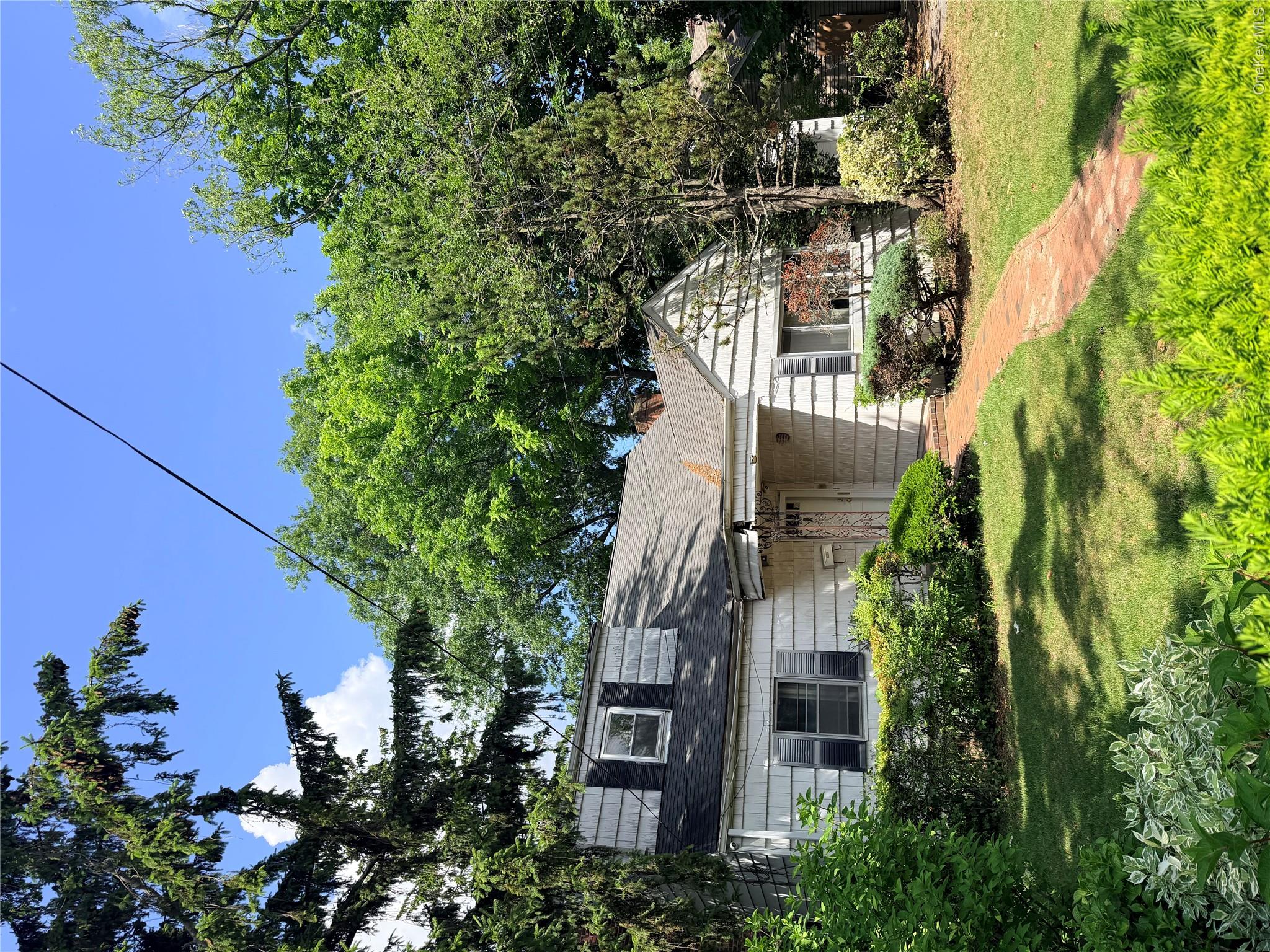 182 East Rockaway Road Hewlett, NY 11557 - Photo 2 of 8 Shingled exterior home with a brick pathway