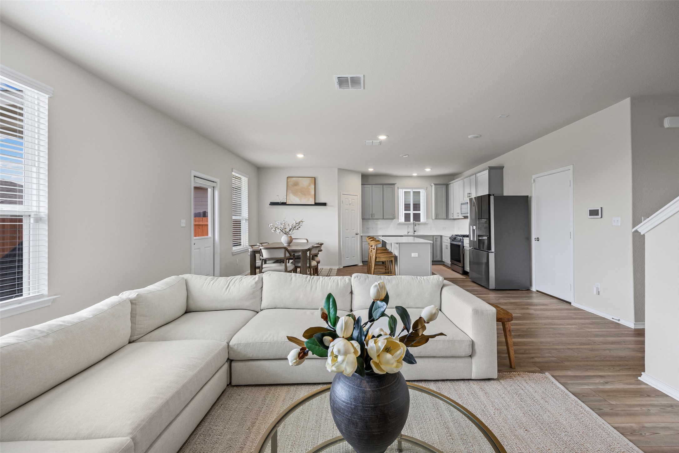 208 Orange Road Buda, TX 78610 - Photo 31 of 31 An open floorplan seamlessly connects the living room, dining area, and a well-appointed kitchen.