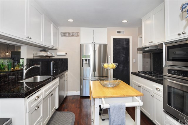 2612 Redlands Drive Costa Mesa, CA 92627 - Photo 12 of 30 a kitchen with stainless steel appliances granite countertop a sink stove and refrigerator