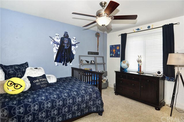 2612 Redlands Drive Costa Mesa, CA 92627 - Photo 16 of 30 a bedroom with a bed and a chandelier