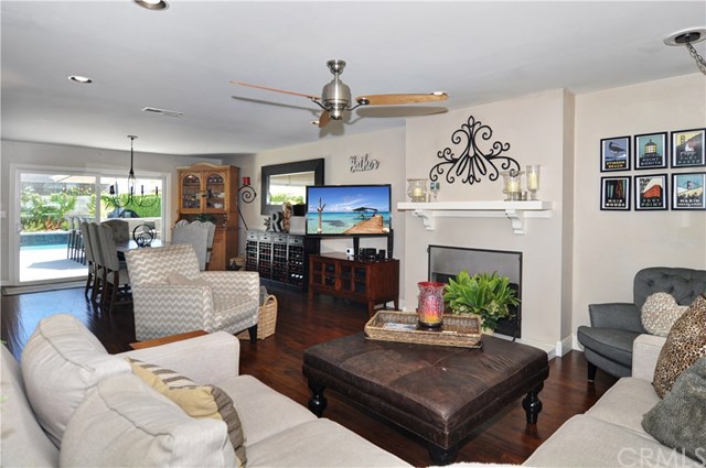 2612 Redlands Drive Costa Mesa, CA 92627 - Photo 5 of 30 a living room with furniture a fireplace and a chandelier