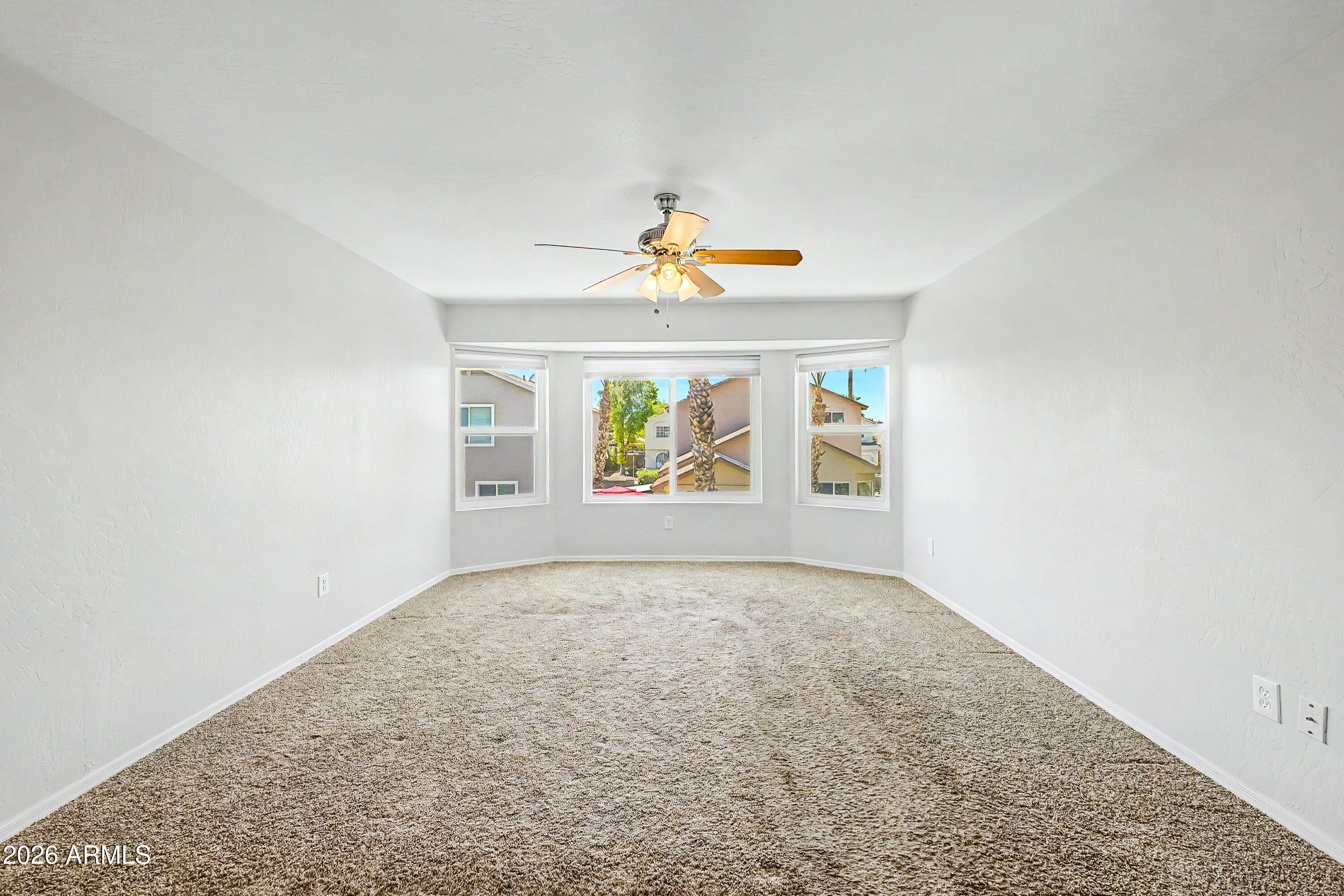 3134 East McKellips Road, Unit 221 Mesa, AZ 85213 - Photo 12 of 29 an empty room with windows and fireplace