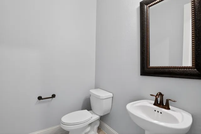 a bathroom with a sink a mirror and a toilet