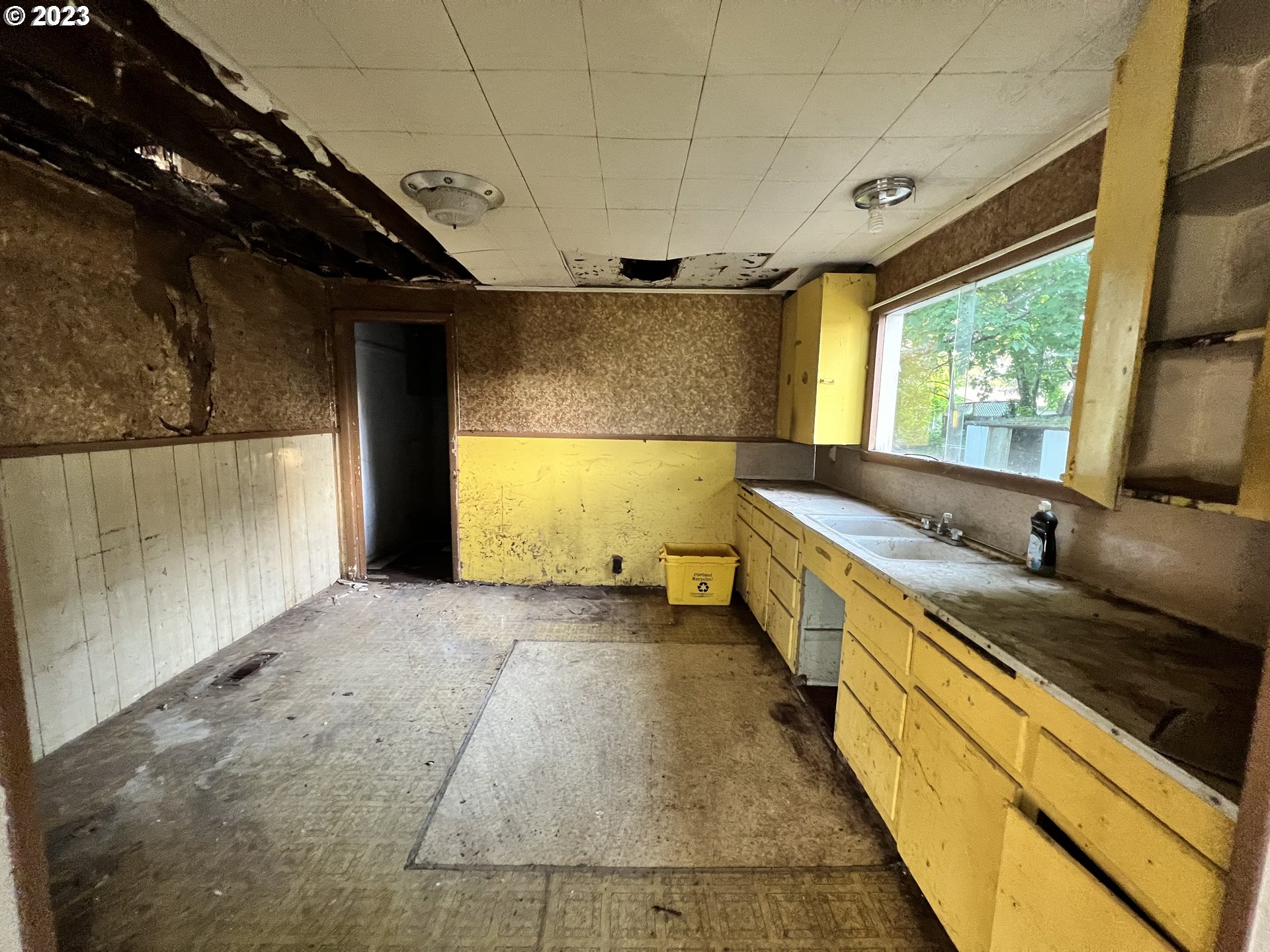 16920 East Burnside Street Portland, OR 97233 - Photo 5 of 8 a kitchen with a sink and large windows