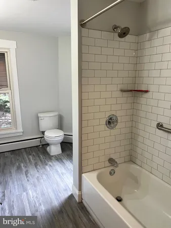 a bathroom with a toilet and a bathtub