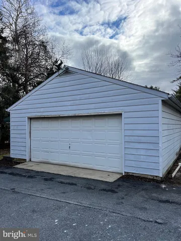 a small barn with a table and chair