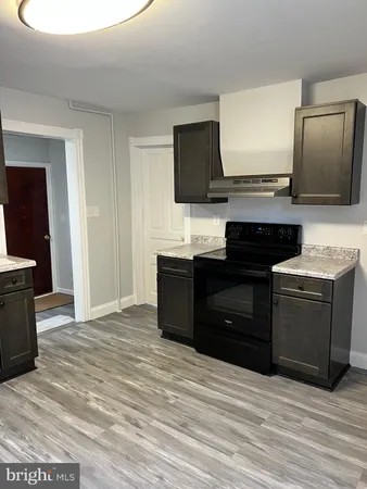 a kitchen with a sink and a stove top oven
