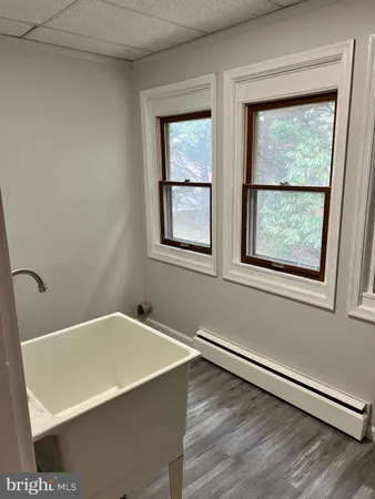 a bath tub sitting in a bathroom next to a window