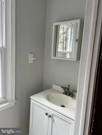 a bathroom with a sink and a window