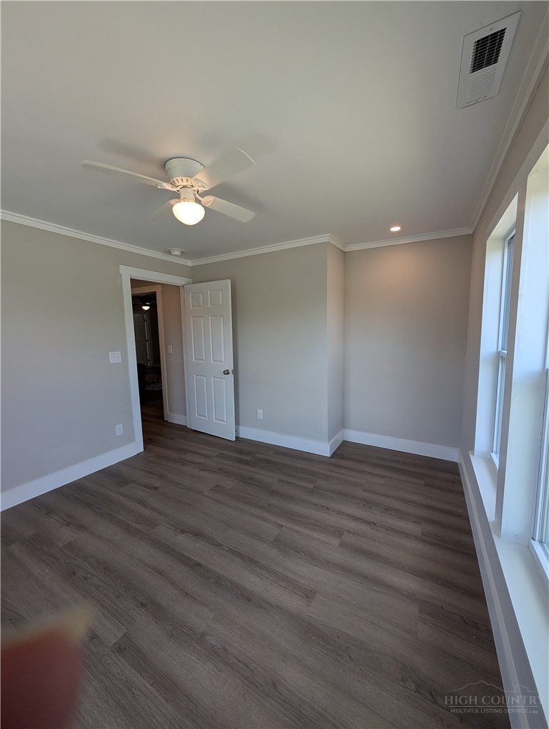 68 Estep Street Sparta, NC 28675 - Photo 9 of 21 a view of empty room with wooden floor and fan