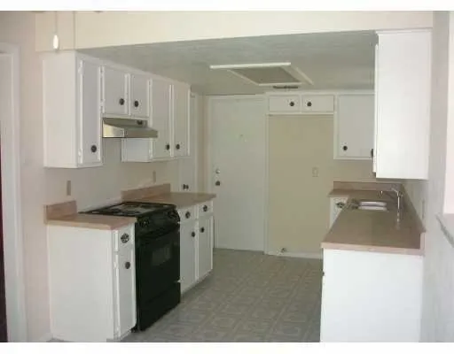 a kitchen with a stove and a refrigerator