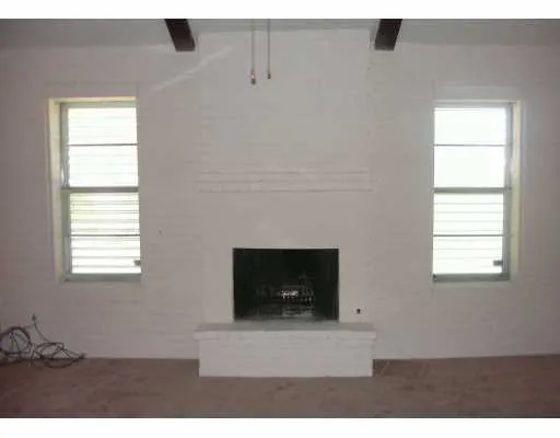 a living room with a fireplace and a window
