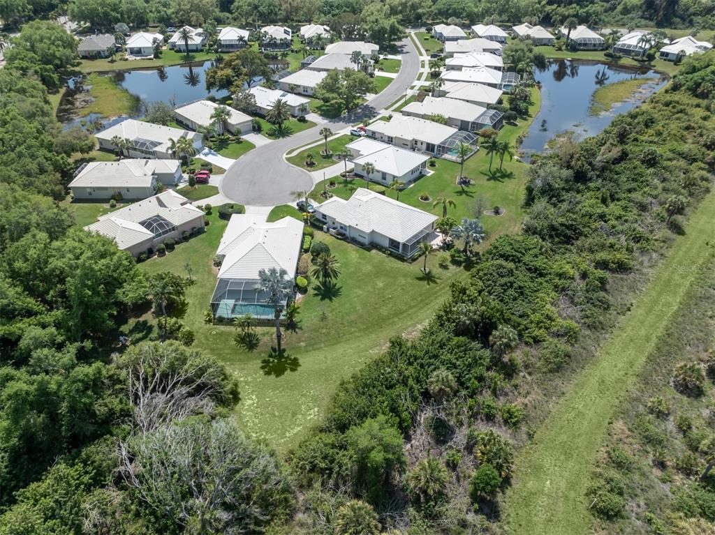 757 Pond Lily Way Venice, FL 34293 - Photo 32 of 53 an aerial view of residential houses with outdoor space and trees