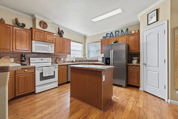 a kitchen with stainless steel appliances a refrigerator stove and sink