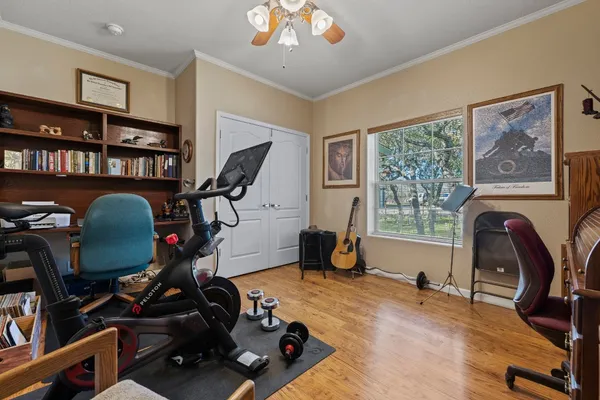 a view of a workspace with furniture and a window