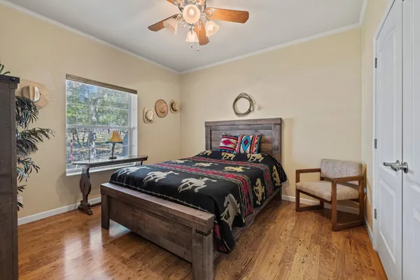 a bedroom with a bed and wooden floor
