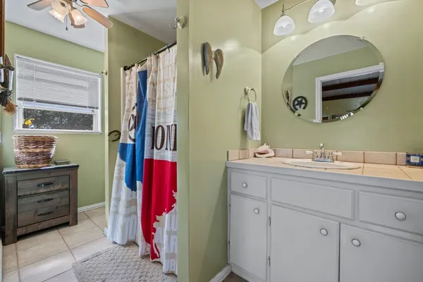 a bathroom with a sink vanity and mirror