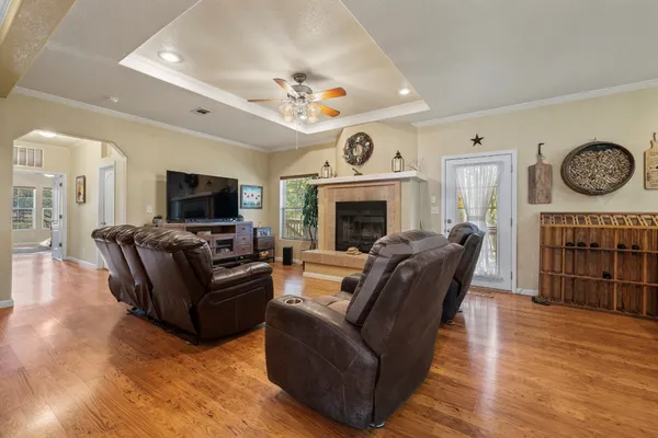 a living room with furniture a fireplace and a flat screen tv