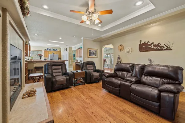 a living room with furniture a fireplace and a chandelier